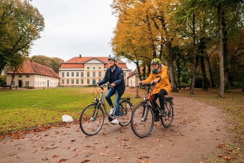 Zwei Freundinnen mit dem Fahrrad auf dem Weg zum Herrenhaus.