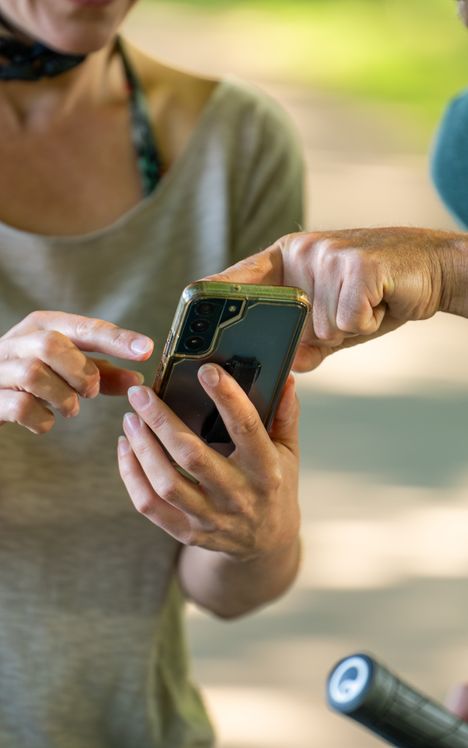 Zwei Radfahrer planen Ihre weitere Radtour auf dem Handy